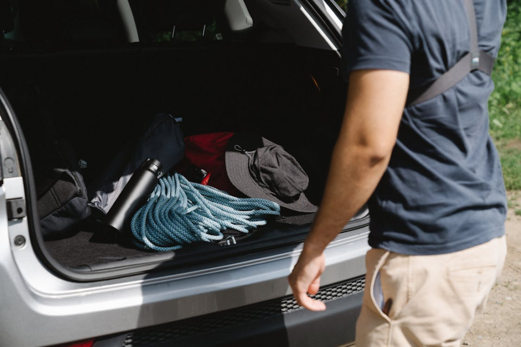 man packing items for camping trip